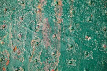 Old grungy green metal deck with rivets, top view, frontal background photo texture