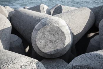 Gray concrete breakwater blocks. Background photo texture