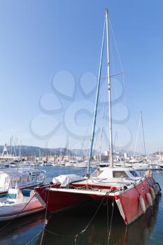 Red catamaran yacht  moored in marina of Ajaccio. Corsica, French island in the Mediterranean Sea