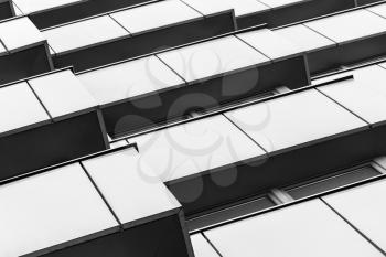 Abstract fragment of modern architecture, walls of steel with dark windows