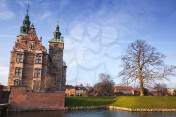 Cityscape of Copenhagen, Denmark with Rosenborg Castle and bare tree in park at winter day