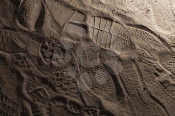 Footprints in dark dusty ground, background photo texture