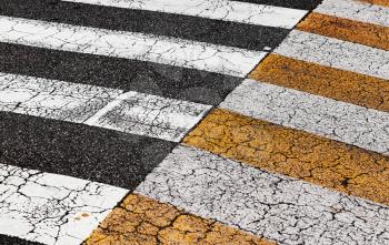 Pedestrian crossing road marking zebra on old dark asphalt, background photo