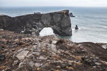 Natural stone arch. Scenic landscape of Dyrholaey Nature Reserve, south coast of Iceland