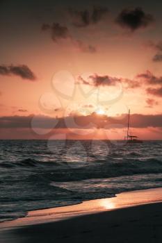 Colorful sunrise over Atlantic ocean. Dominican republic, Punta Cana beach, vertical photo