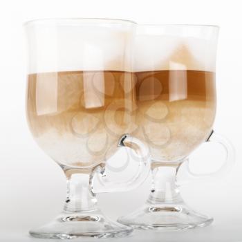 Two big glass mugs with handles of latte coffee, macro photo