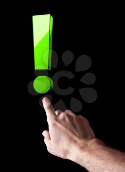 Man's hand shows big green exclamation mark  isolated on black background