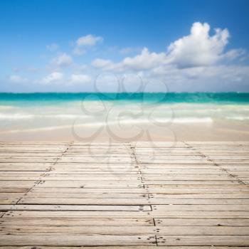 Square photo with empty wooden pier and blurred sea landscape on a background