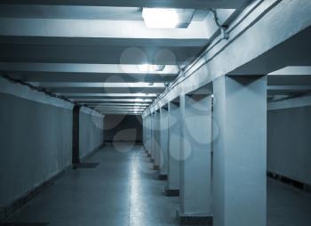 Underground passage with lights and concrete columns 