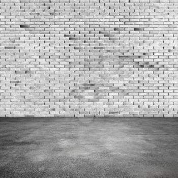Empty abstract interior background with white brick wall and asphalt floor