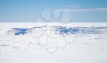 Empty winter background landscape. Blue sky, snow on frozen Baltic Sea