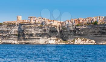 Living houses and fortress tower on rocky coast of Bonifacio, mountainous Mediterranean island Corsica, Corse-du-Sud, France