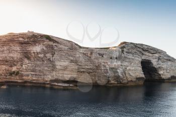 Bay of Bonifacio, coastal rocks with big grotto. Mountainous Mediterranean island Corsica, Corse-du-Sud, France