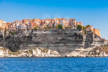 Colorful living houses on rocky coast of Bonifacio, mountainous Mediterranean island Corsica, Corse-du-Sud, France