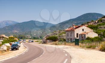 Rural landscape of Corsica island. Old abandoned stone house near a highway, Piana region, France