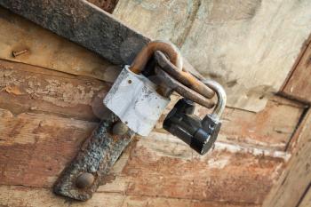 Old locks hanging on wooden door