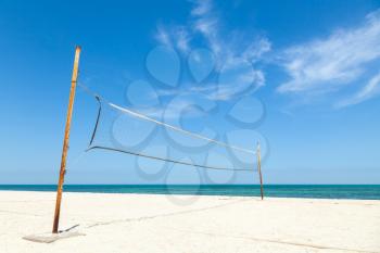 Net for beach volleyball on empty sea coast