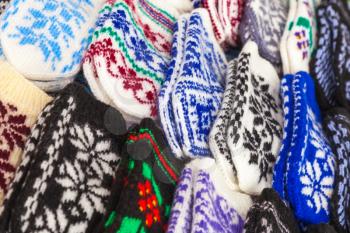 Colorful woolen mittens lie on the market counter 