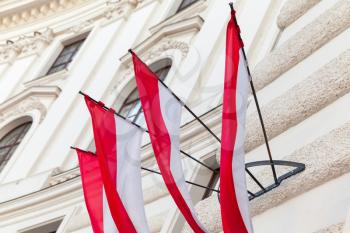 Flags of Vienna city hanging on white building facade, Austria