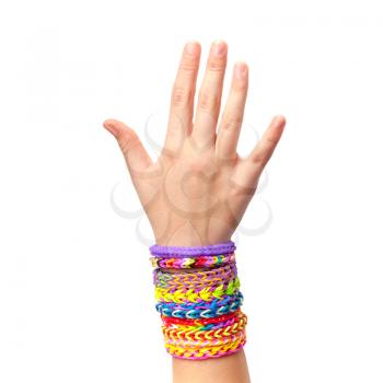 Child hand with colorful rubber rainbow loom bracelets isolated on white background, trendy teenagers fashion accessories 
