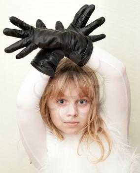 Little blond girl shows a deer with antlers as a gloves