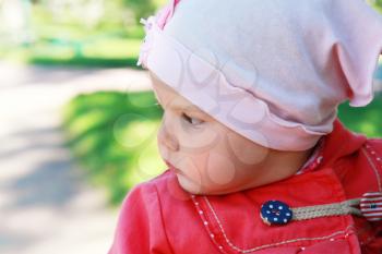 Little baby girl in the park, closeup portrait