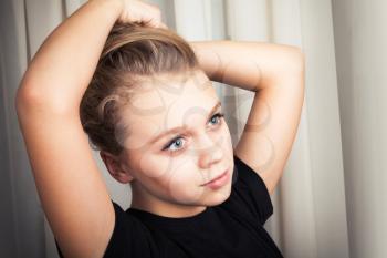 Beautiful blond Caucasian girl, closeup studio portrait