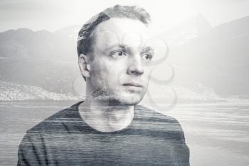 Young adult Caucasian man portrait combined with coastal mountains landscape, double exposure photo effect