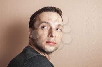 Young Caucasian proud man portrait over gray wall background, vintage tonal correction photo filter effect