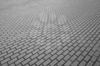 Small-scale background texture of modern gray cobblestone pavement