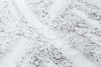 Background texture of road covered with wet snow