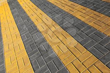 Pedestrian crossing road marking. Yellow rectangles on cobblestone road