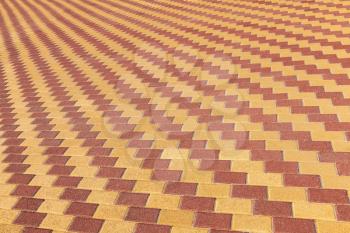 Background texture of red and yellow cobblestone pavement pattern