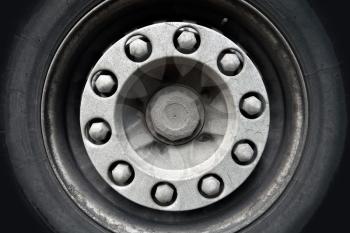 Abstract transportation background. Closeup photo texture of cargo truck wheel