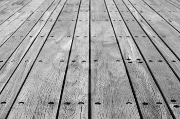 Gray wooden floor made of boards with bolts, background photo with perspective effect and selective focus