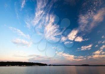 Colorful sunrise cloudscape background. Early morning on the Saimaa lake in Karelia, Finland