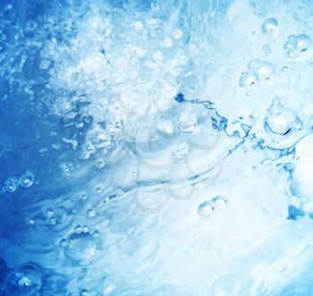 Abstract blurred blue water surface background with ripple and air bubbles