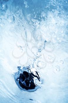 Abstract blurred blue bath background with black cover under water