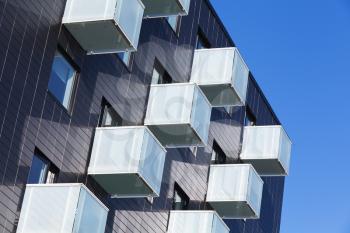 Abstract fragment of contemporary architecture, cube shaped balconies with white glass railings