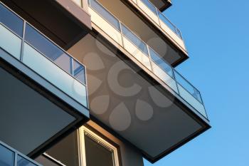 Abstract fragment of contemporary architecture, balconies with glass railings