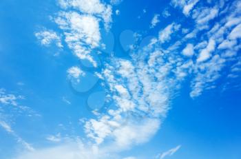 Natural bright blue sky with white altocumulus clouds, background photo texture