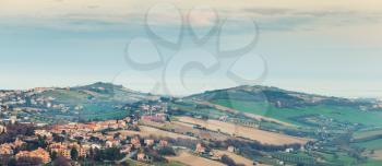 Rural panorama of Italian countryside. Italy, Province of Fermo. Vintage toned photo with old style filter