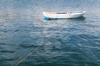 White wooden fishing boat floats on still water of Marmara Sea, Istanbul, Turkey