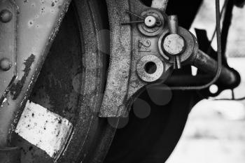 Old wheel with brake details of industrial railway carriage, stylized black and white close up photo