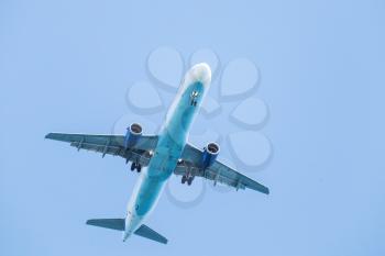 Passenger plane flying in clear blue sky