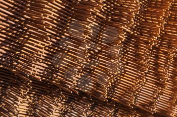 Abstract industrial background with stack of rusted reinforcing mesh elements, photo with selective focus