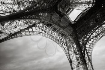 Eiffel tower bearings fragment, the most popular landmark of Paris, France. Monochrome photo with retro style effect