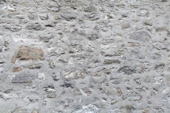 Ancient fortress wall made of gray stones, background photo texture