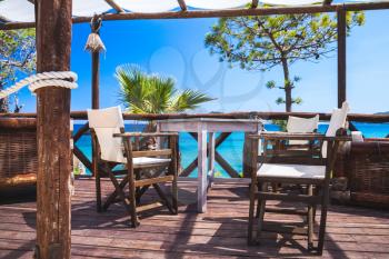 Seaside balcony with wooden furniture, popular touristic resort island Zakynthos, Greece