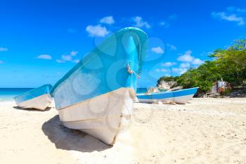 Pleasure boat lays on white sand of Macao Beach, coastal landscape. Dominican Republic, Hispaniola Island